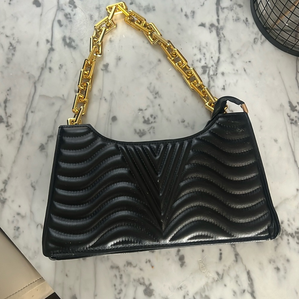 Black purse with gold handle
